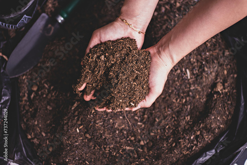 Dirty woman hands holding dark moist soil. Agriculture, organic gardening, planting or ecology concept. Environmental, earth day. Banner. Top view. Copy space. Farmer checking before sowing.