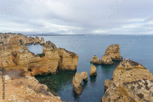 Famous rock formation of cliff in golden sunlight at the atlantic coast line near Ponta da Piedade  Lagos  Algarve  Portugal.