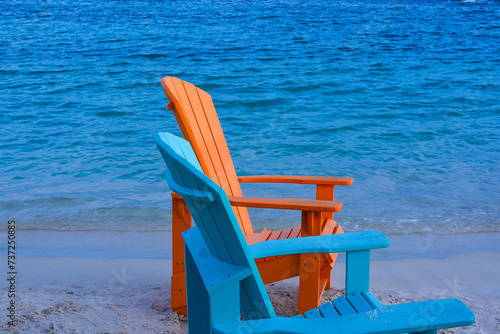 Colorful wooden chairs on beach at Caribbean coast. 