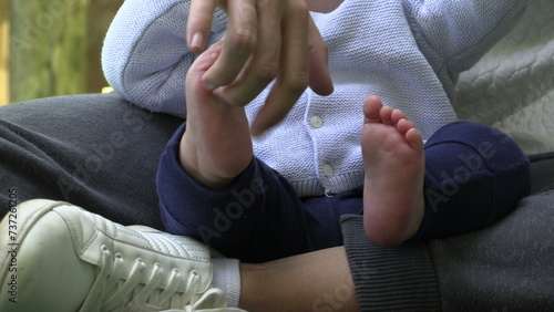 Mother tickling baby foot infant with mom photo