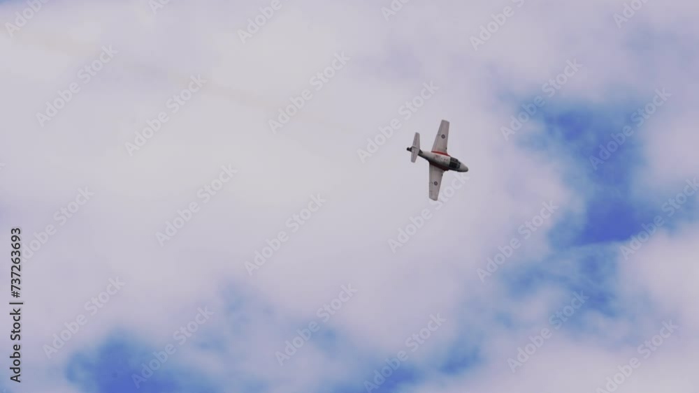 Panning Shot Of Aircraft Flying In White Cloudy Sky - Huntington Beach, California Panning Shot Of Aircraft Flying In White Cloudy Sky - Huntington Beach, California