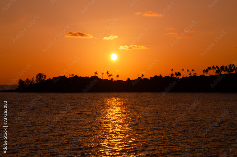 Beautiful sunset tropical beach with palm tree and orange sky for travel and vacation in holiday relax time.