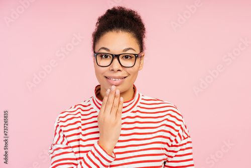Attractive smiling African American woman wearing stylish eyeglasses speaking with sign language photo