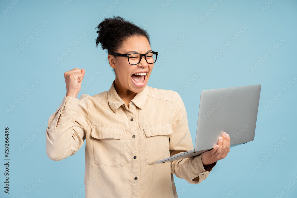 Attractive smiling woman gesturing, win money, using laptop, watching video, online shopping Attractive smiling woman gesturing, win money, using laptop, watching video, online shopping