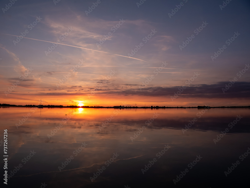 Sunset over De Morra lake in summer, Friesland, Netherlands