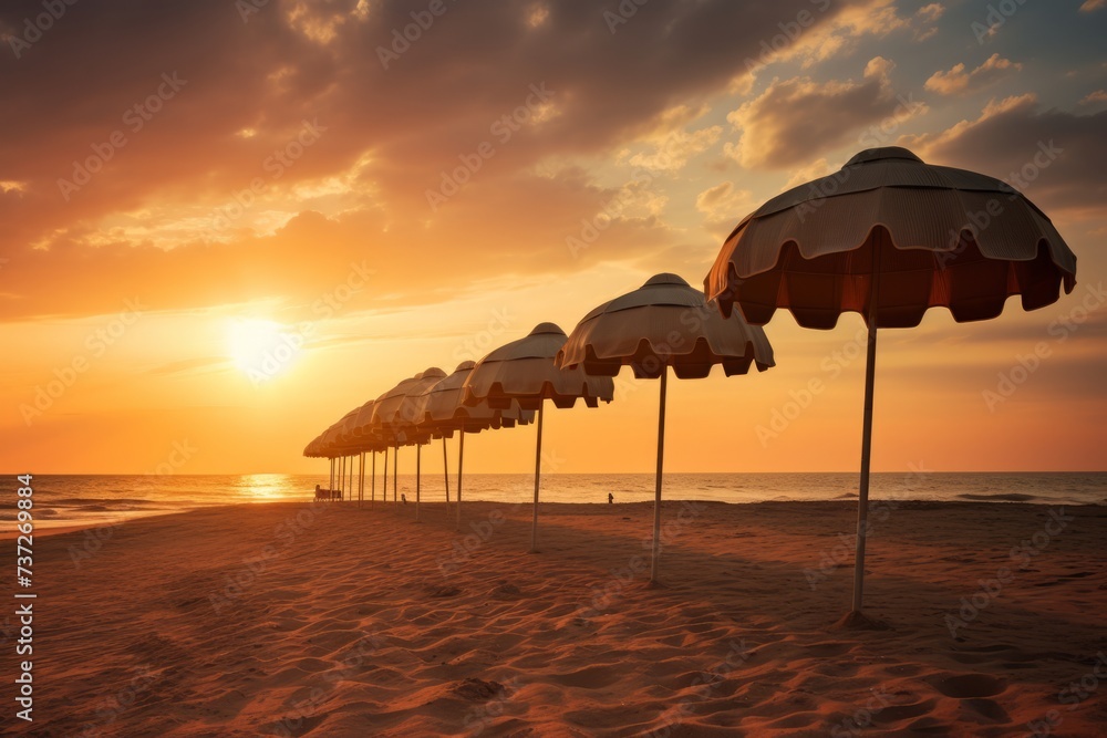 A row of beach umbrellas at sunrise