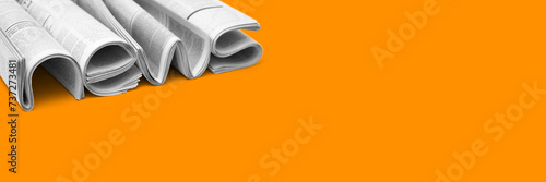 Modern newspapers are folded and composing together the word NEWS, isolated over background. Concept of business news, news media, print media and mass media at all. Copy space for your text