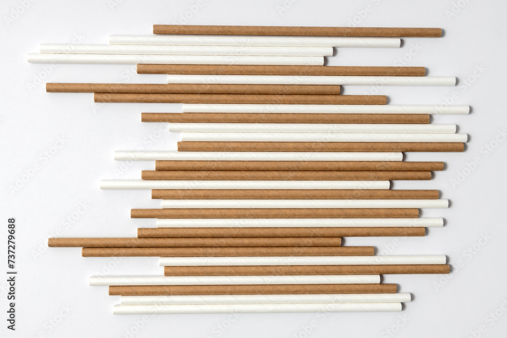 Top view of brown and whie straws on the white background Top view of brown and whie straws on the white background