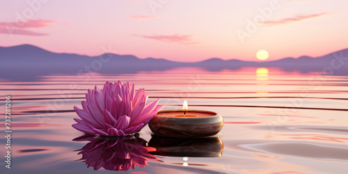 Lotus flower and burning candle are floating on a pond photo
