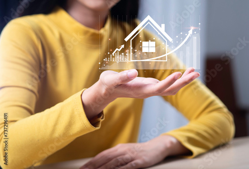 Woman touches virtual house icon to analyze home loan and real estate mortgage insurance interest rate investment planning Real estate business Real estate investment ideas