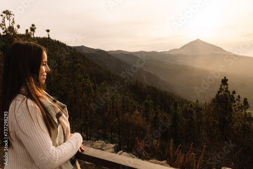 Woman at the lookout point observing the Teide in the background