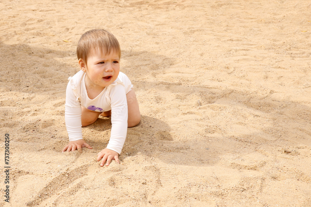 cute little baby barefoot on the sand with copy space cute little baby barefoot on the sand with copy space