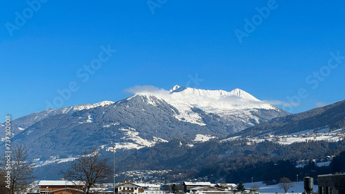 Scenic view of a snow-capped mountain peak  Austria. A winter wonderland in the Austrian Alps. Holidays for Christmas. Mountain landscape. Mobile photo.