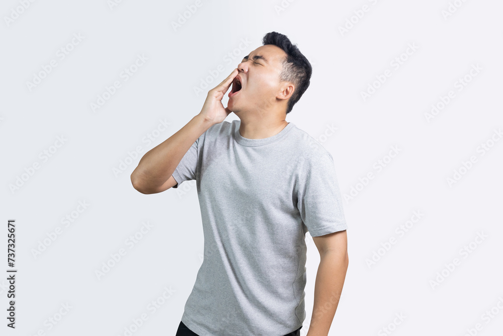 Portrait of man yawning sleepy isolated on white background Portrait of man yawning sleepy isolated on white background