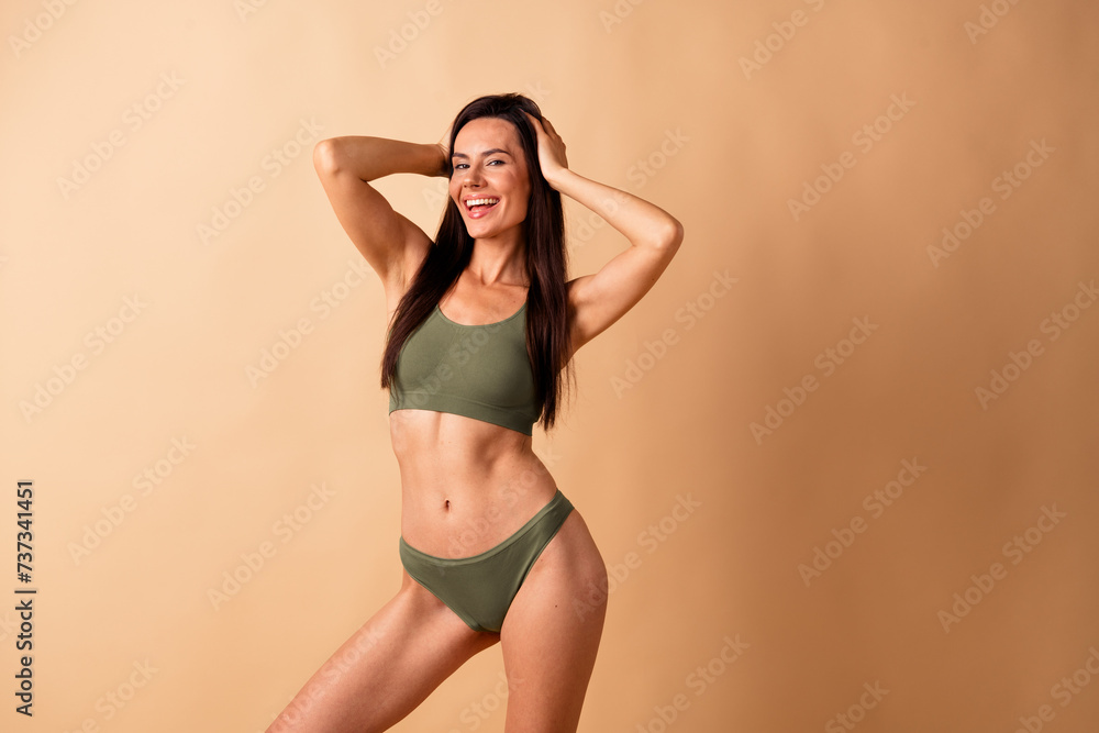 Obraz premium Photo portrait of attractive young woman touch head cool model no retouch wear trendy khaki lingerie isolated on beige color background