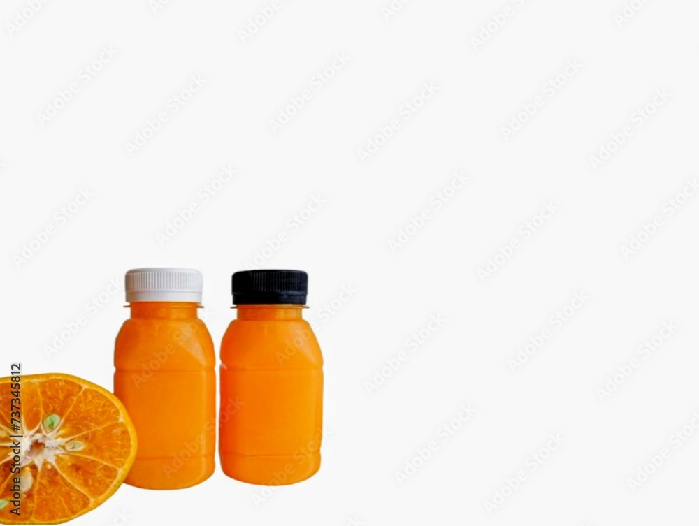 The white background in the picture is a bottle.The image has a white background and two small orange juice bottles with white and black caps close together. There is also a halved orange placed The white background in the picture is a bottle.The image has a white background and two small orange juice bottles with white and black caps close together. There is also a halved orange placed