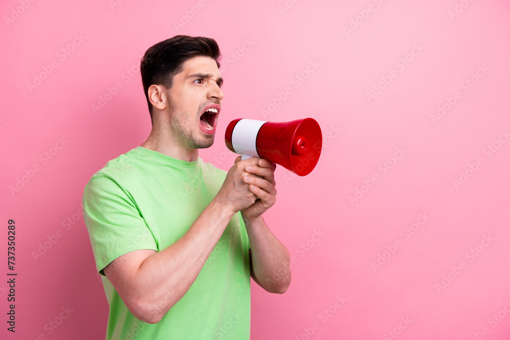 Photo of young furious man bossy screaming loud speaker to empty space announce ukrainian public protest isolated on pink color background Photo of young furious man bossy screaming loud speaker to empty space announce ukrainian public protest isolated on pink color background