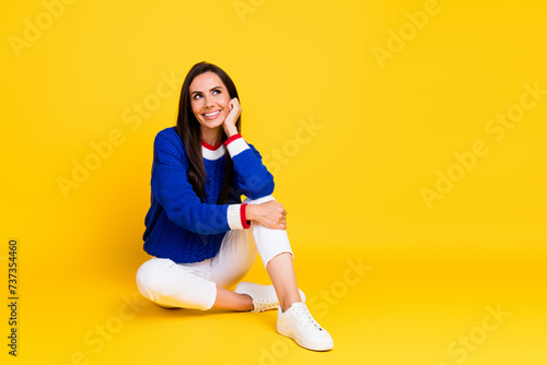 Full body size photo of brunette hispanic lady in blue jumper touch cheek daydream looking copyspace isolated on yellow color background