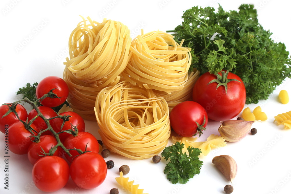 Pasta in the form of a nest with vegetables and herbs lies on a white background. Pasta in the form of a nest with vegetables and herbs lies on a white background.