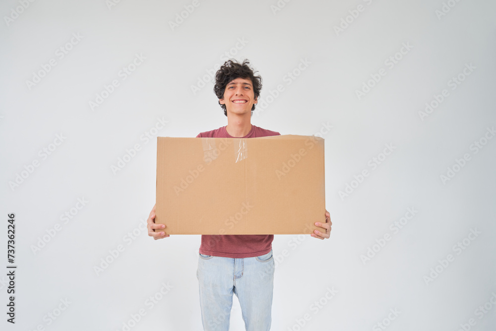 Young man holds cardboard house, concept moving in, real estate, freight, mortgage. Young man holds cardboard house, concept moving in, real estate, freight, mortgage.