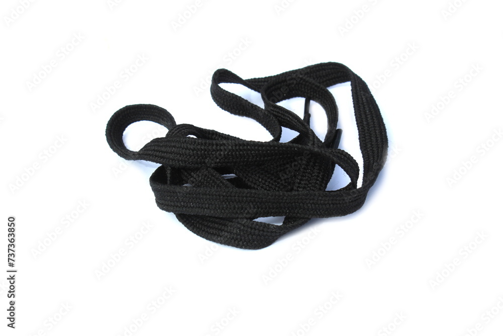 A twisted black cord lies on a white background. A twisted black cord lies on a white background.