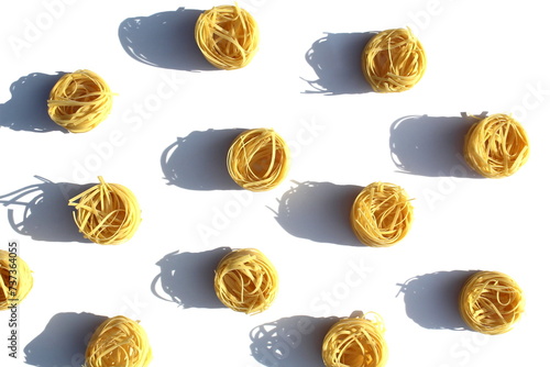 Texture of pasta in the form of a nest on a white background.