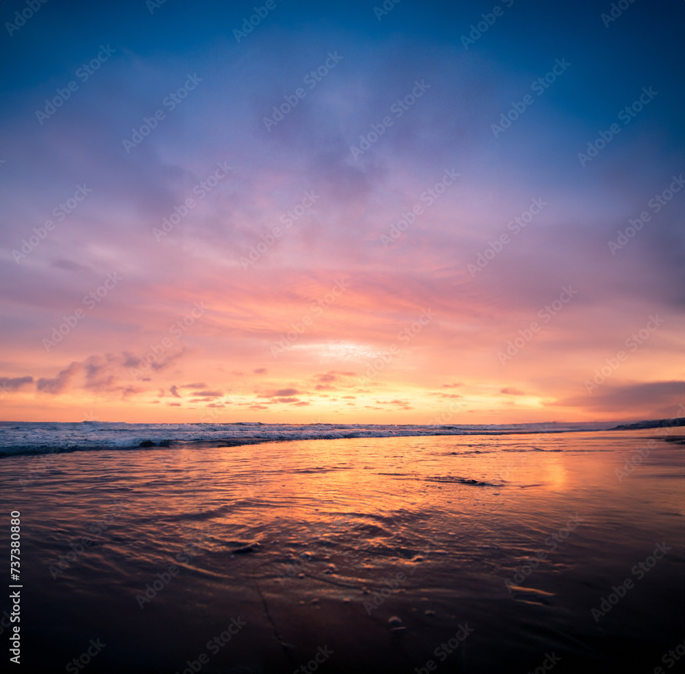 Vertical shot of a body of water with the pink sky during sunset. Perfect for a wallpaper.