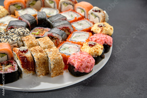 Classic and baked sushi rolls assortment; Philadelphia rolls topped with spicy sauce, a mix of warmth and tradition