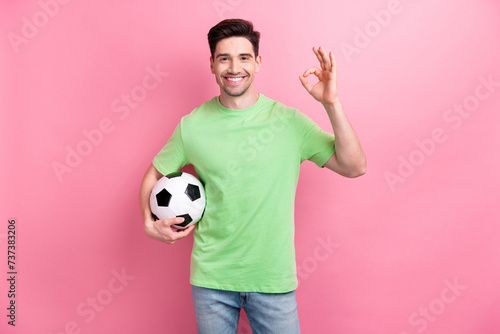 Quadro su tela Photo of guy okay sign wearing green t shirt holding football ball recommend vis