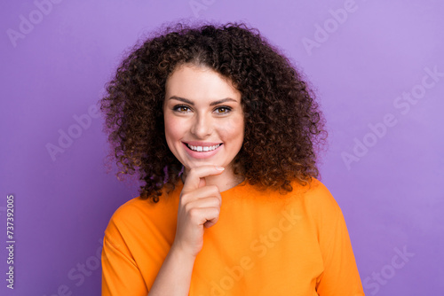 Photo of pretty cute woman wear orange t-shirt smiling arm chin isolated purple color background