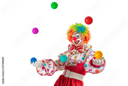 Funny clown juggler. Entertainer professional actor in colorful suit and wig juggling with colorful balls. Joker jester, pantomime, mime with clown whiteface makeup at event, kids party, circus