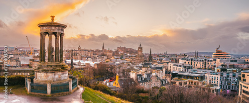 Calton Hill panoramic view of the Edinburgh skyline at sunset, with the Dugald Stewart monument in the foreground