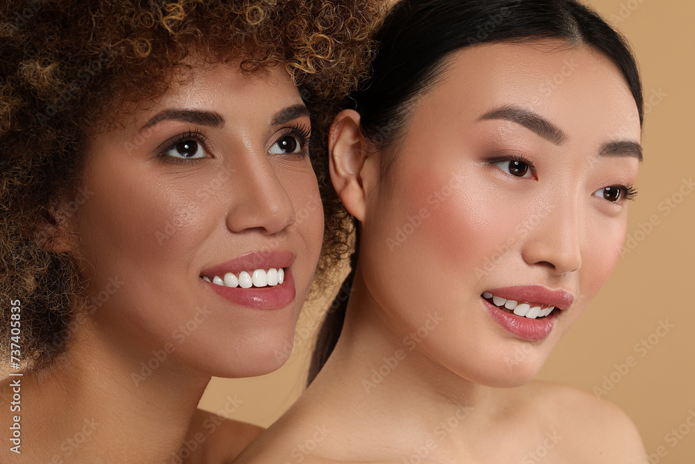 Beautiful young women with healthy skin on beige background Beautiful young women with healthy skin on beige background