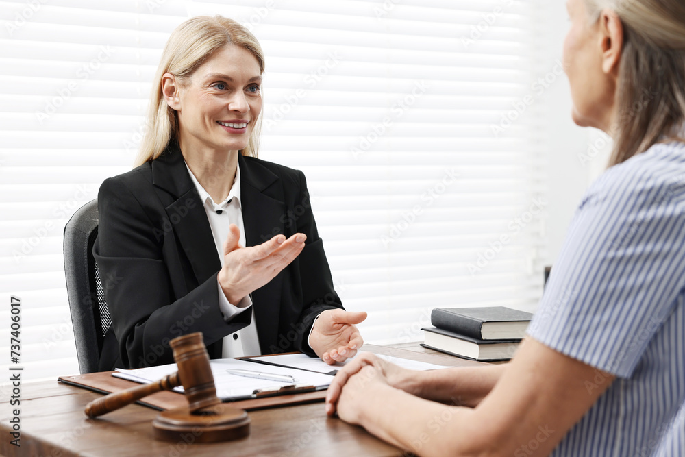 Senior woman having meeting with lawyer in office Senior woman having meeting with lawyer in office