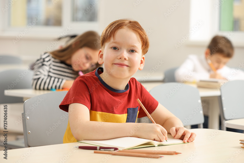 Portrait of cute little boy studying in classroom at school Portrait of cute little boy studying in classroom at school