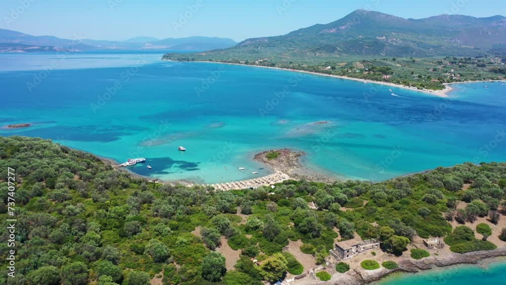 Aerial drone video of tropical paradise exotic island bay covered in limestone trees with emerald crystal clear beach visited by luxury yachts and sail boats in Caribbean destination Aerial drone video of tropical paradise exotic island bay covered in limestone trees with emerald crystal clear beach visited by luxury yachts and sail boats in Caribbean destination