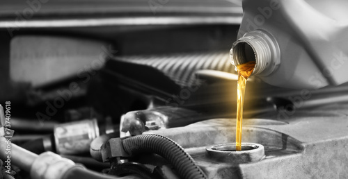 Pouring motor oil into car engine, color accent effect. Banner design