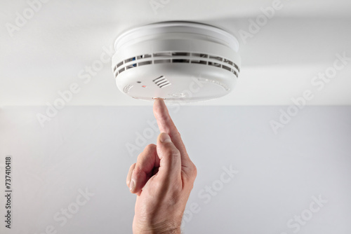 Home smoke and fire alarm detector checking, testing or replace battery photo