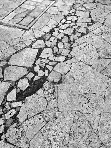 Detail of a floor made of pieces of Roman travertine, damaged by time.