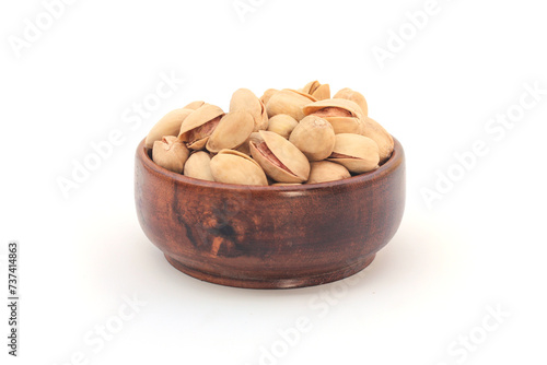 Pistachio nuts, pistachios in Wooden Bowl Isolated on a white background. 