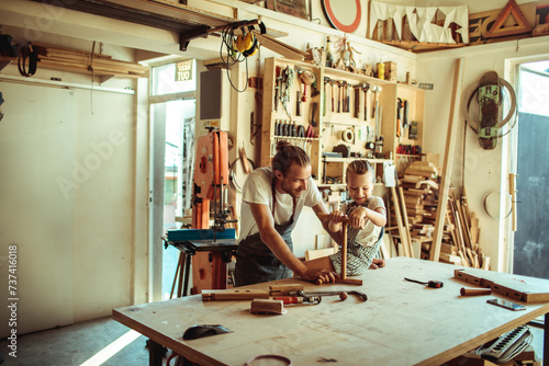 Father and daughter enjoying woodworking in a home workshop