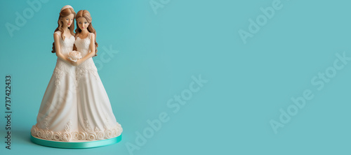 Two brides in white dresses figurine. Lesbian marriage concept. Banner with copy space. photo