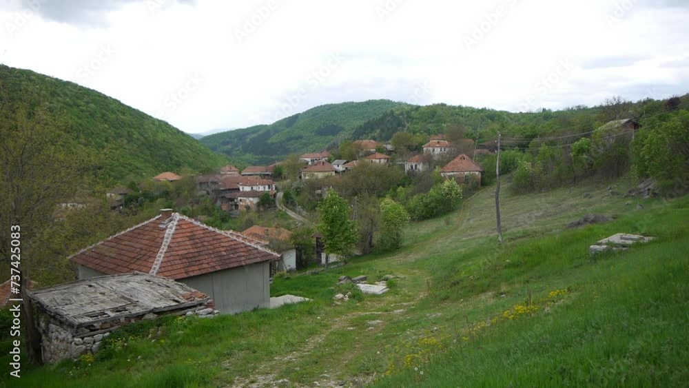 Panoramic view of the village of Kandalica in Eastern Serbia in early spring. Abandoned houses without inhabitants in newly green spring nature Panoramic view of the village of Kandalica in Eastern Serbia in early spring. Abandoned houses without inhabitants in newly green spring nature