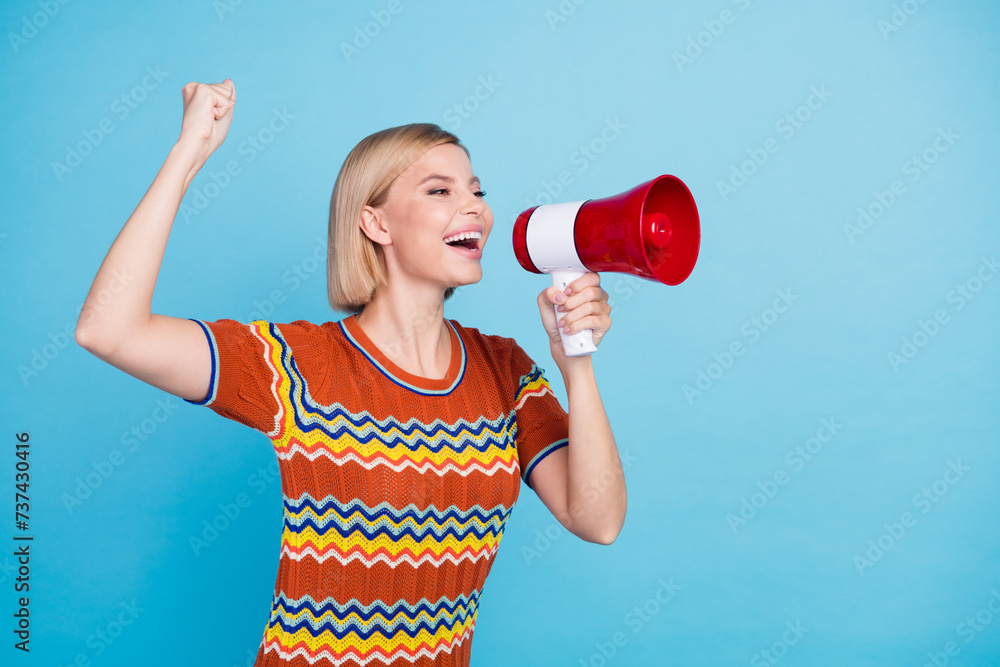 Portrait of good mood energetic woman with bob hairstyle scream in megaphone to empty space support team isolated on blue color background