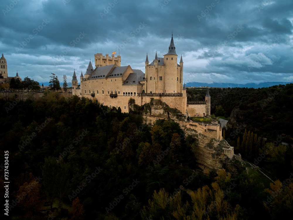 The Alcazar of Segovia a medieval castle with cloud sky and forest