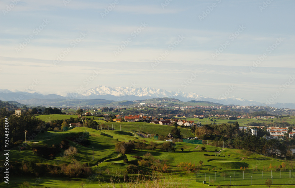 Obraz premium Cantabria, view inland over Liencres area, snow on Picos de Europa mountain range