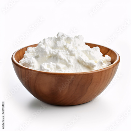 Fresh cottage cheese in a wooden plate on a white background. Isolated