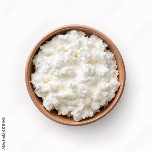 Cottage cheese in a wooden bowl isolated on a white background. Top view. Flat lay