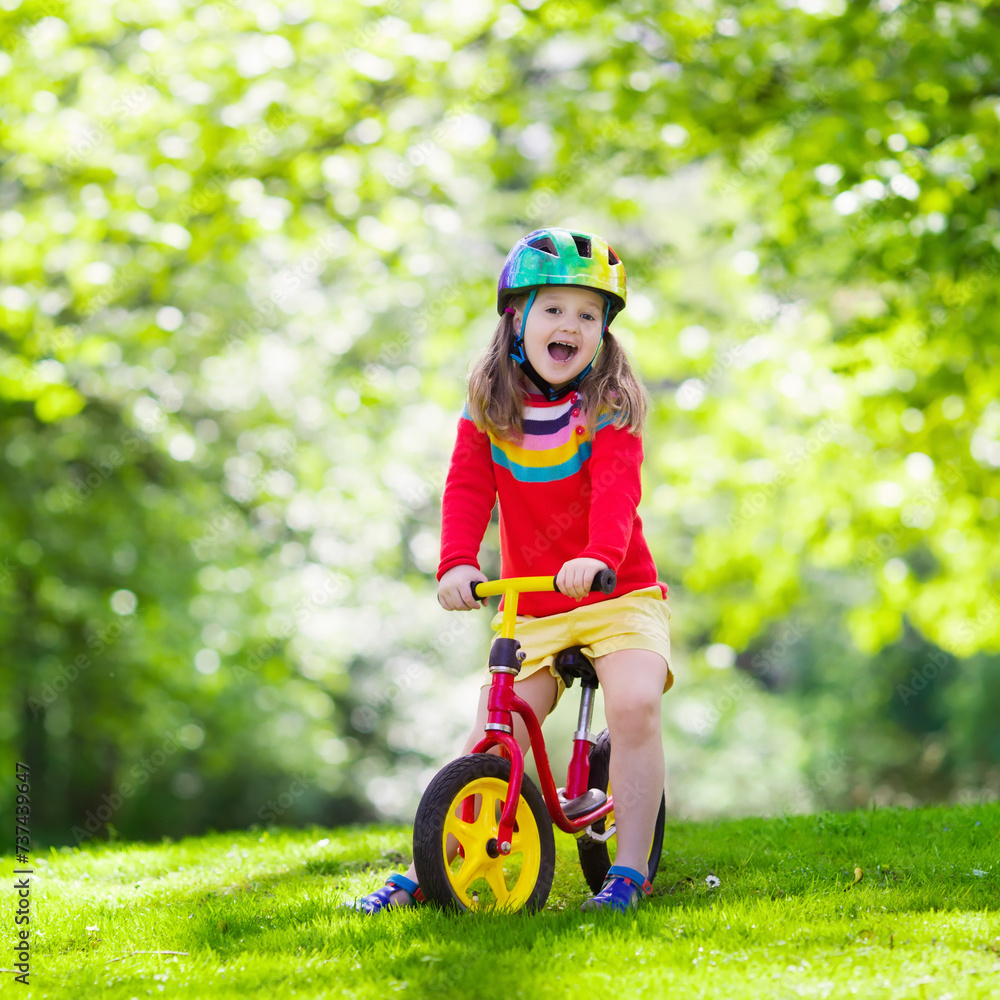 Kids ride balance bike in park Kids ride balance bike in park