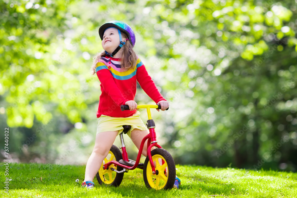 Kids ride balance bike in park Kids ride balance bike in park